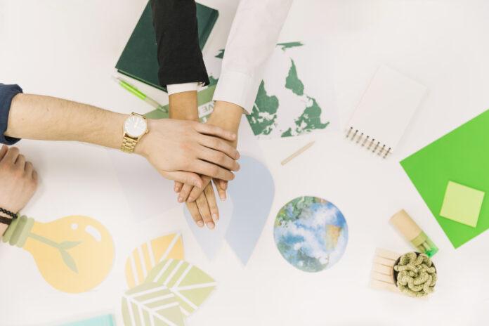 group-of-businesspeople-stacking-their-hands-over-desk