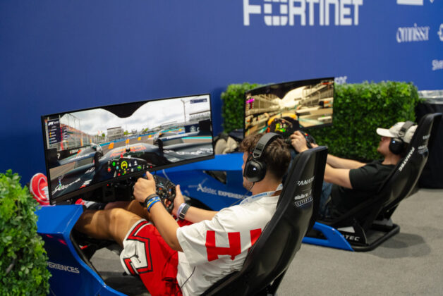 Asistentes del Adistec Connect F1 Experience jugando con los simuladores.